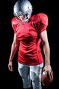American football player looking down while standing Royalty Free Stock Photo