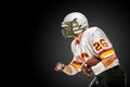 American football player posing with ball on black background. Super Bowl concept. Concept American football, portrait Royalty Free Stock Photo