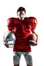 American football player in red jersey holding helmet and ball Royalty Free Stock Photo