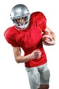 American football player in red jersey looking down while holding ball Royalty Free Stock Photo