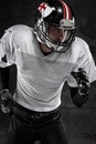 American football player running dark background Royalty Free Stock Photo