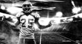 American football player, athlete in helmet on stadium. Black and white photo. Sport wallpaper with copyspace. Royalty Free Stock Photo
