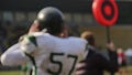 American football player walking out on field, team substitution, sports career