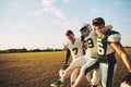 American football players carrying an injured teammate off the field Royalty Free Stock Photo