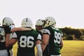 American football players standing in a huddle during team pract Royalty Free Stock Photo