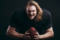 Determined American football player in action isolated on black background Royalty Free Stock Photo