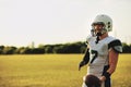 American football quarterback standing on a field holding a ball Royalty Free Stock Photo