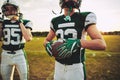 American football quarterback standing with his team on a field Royalty Free Stock Photo