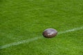 American football, rugby ball on green grass field background Royalty Free Stock Photo