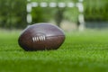 American football, rugby ball on green grass field background Royalty Free Stock Photo