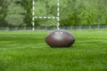 American football, rugby ball on green grass field background Royalty Free Stock Photo