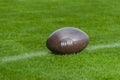 American football, rugby ball on green grass field background Royalty Free Stock Photo