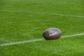 American football, rugby ball on green grass field background Royalty Free Stock Photo