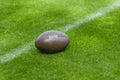 American football, rugby ball on green grass field background Royalty Free Stock Photo