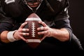 American football sportsman player on stadium with lights on black background. Royalty Free Stock Photo