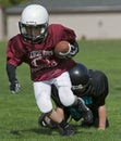 American Football tackle in his wake Royalty Free Stock Photo