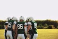 American football team in a huddle on a sports field Royalty Free Stock Photo