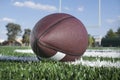 American Football on turf field with goal post in view Royalty Free Stock Photo