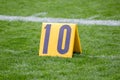 American Football 10 yard marker on grass by the line Royalty Free Stock Photo