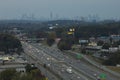 American freeway with fast driving cars and trucks and highrise skyscrapers of Atlanta city in Georgia state. View from