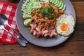 American fried rice is served with sausages, cucumbers, shredded vegetables in a gray plate on a slatted table with seasonings Royalty Free Stock Photo