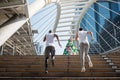 American friends run upstair in city Royalty Free Stock Photo