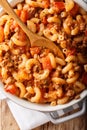 American goulash made from pasta with tomatoes, spices and ground beef close-up. Vertical top view