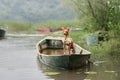 An American Hairless Terrier dog in a canoe amidst calm waters.