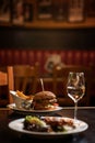 American hamburger with glass of beer or wine in restaurant, beer, hamburger, wine and other american specialites