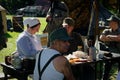 WWII Red Cross nurse and soldiers have a meal under a tent