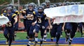 American High School football team enters field Royalty Free Stock Photo