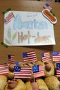 American hot dogs with small American flags close plan, bun and sausage and an inscription american hot dogs on paper Royalty Free Stock Photo