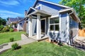 American house exterior with blue siding trim and small concrete floor porch Royalty Free Stock Photo