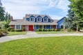 American house exterior with blue and white trim. Also red front door Royalty Free Stock Photo