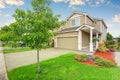 American house exterior with garage, driveway and well kept lawn. Royalty Free Stock Photo