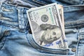 American hundred dollars sticking out of denim pocket close-up Royalty Free Stock Photo
