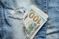 American hundred dollars sticking out of a hole in jeans close up Royalty Free Stock Photo