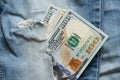 American hundred dollars sticking out of a hole in jeans close up Royalty Free Stock Photo