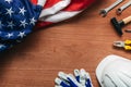 American Labour day concept, top view flat lay with USA flag and tools on wooden desk Royalty Free Stock Photo