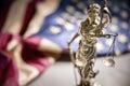 American legal system law concept statue of lady justice with scales of justice and american flag Royalty Free Stock Photo