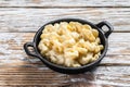 American mac and cheese, macaroni pasta in cheesy sauce. White wooden background. Top view Royalty Free Stock Photo