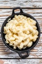 American mac and cheese, macaroni pasta in cheesy sauce. White wooden background. Top view Royalty Free Stock Photo