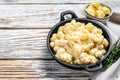 American mac and cheese, macaroni pasta in cheesy sauce. White wooden background. Top view. Copy space Royalty Free Stock Photo