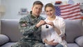 American male soldier and his wife holding house key reward for military service