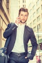 Young man traveling in New York City, talking on cell phone Royalty Free Stock Photo