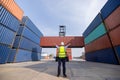 American man Foreman control loading containers box to truck for logistics export  of International global shipping Royalty Free Stock Photo