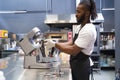 American man preparing dough mixer for cooking