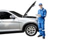 American mechanic with broken car and tablet Royalty Free Stock Photo