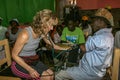 American medical team member checks blood pressure for a male patient during medical mission to rural Haiti.