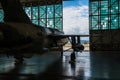 American military bomber aircraft with bombs parked in airport base hangar ready for flight attack.